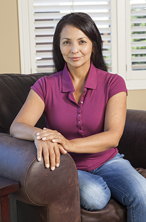 Portrait of woman sitting in chair. 